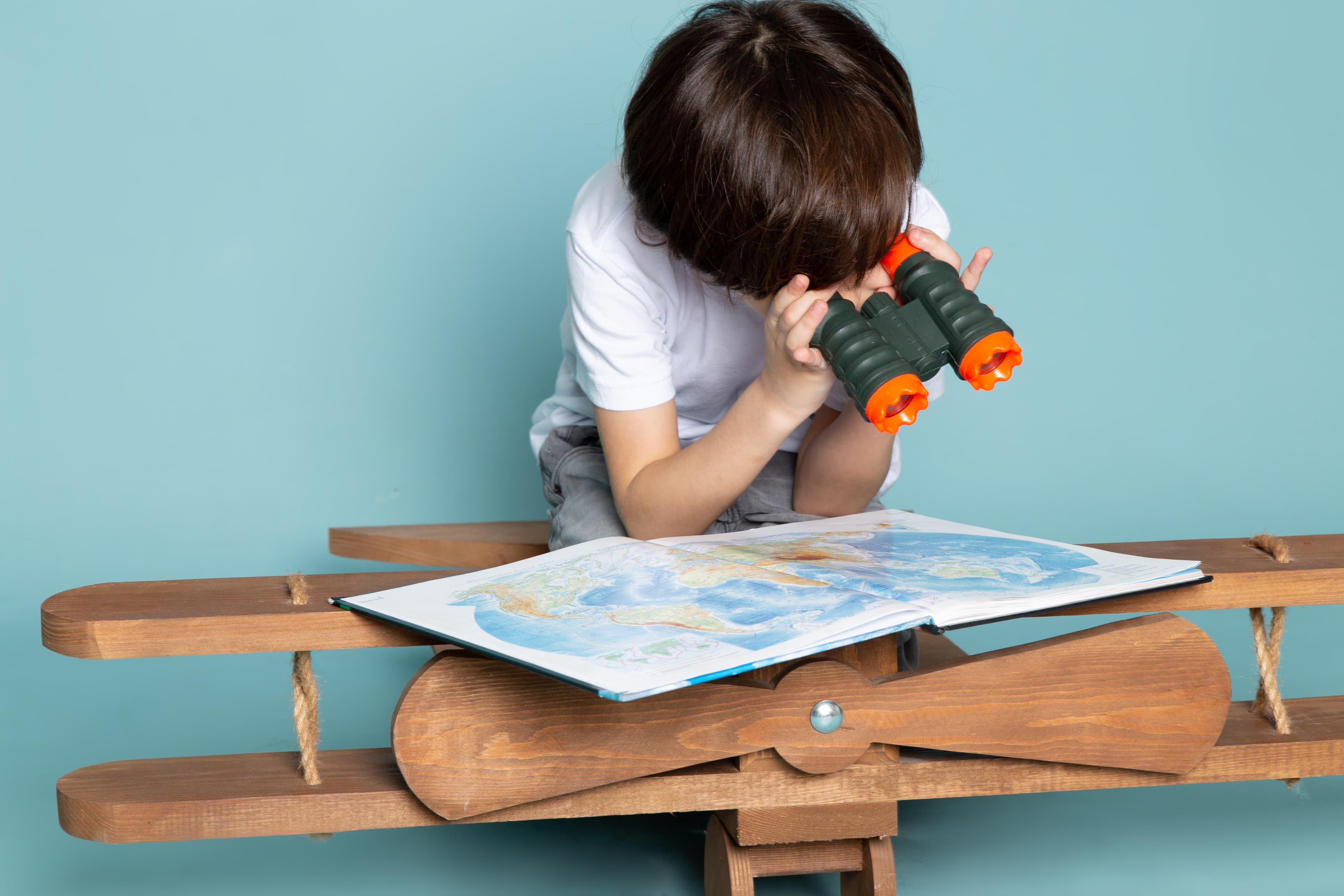 Boy looking through map